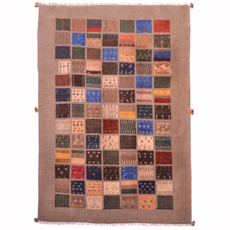 Gabbeh carpet with all over panel design on brown background.