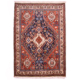 Fine Qashquli Rug with geometric medallion design on a deep blue field with rust corners and cream border.