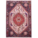 Handwoven wool pile fine Qashqai Rug with cream field, navy corners and terracotta-red medallion.