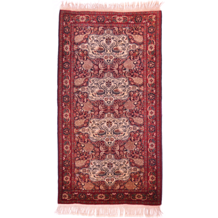 Hand-knotted wool pile old Belouch Tavusi rug with distinctive design of peacocks and other bird motifs; colours of red, black, cream and gold.