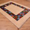 Funky handknotted modern Gabbeh Rug with plain natural beige field and a jazzy multi-colour chequerboard inset border.