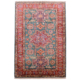 Fine Afghan Kazak medallion design rug with green ground and red border and Lesghi star medallion.