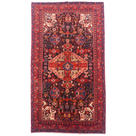 Hand-knotted wool pile Persian Nahavand Kelleghi rug with pink and red medallion on a black field with red border. Rug has numerous inscriptions.