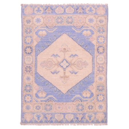 Oushak mat with cream medallion on a light blue ground.