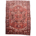 Old Persian Heriz carpet, geometric medallion design with colours of brick red, brown and cream.