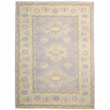 Oushak carpet in grey with geometric medallion design and additional shades of green, yellow and brown.