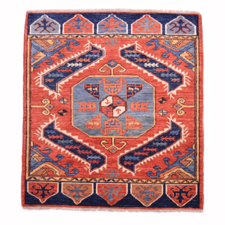 Fine antique style Afghan mat with geometric medallion design on a rust/terracotta ground.