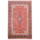 Elegant silk on cotton hand-knotted Indian fine Kashmir Silk rug with floral medallion design featuring a red field with navy medallion and border.