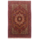 This hand-knotted Persian Gholtog rug has a geometric medallion design with colours of black, brown and cream.
