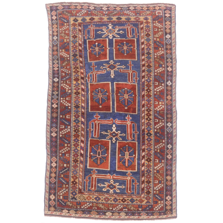 Blue ground with rust, cream & gold antique karagashli rug with geometric design.